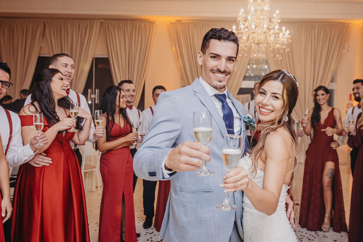 Newlyweds and guests toasting with champagne at a reception